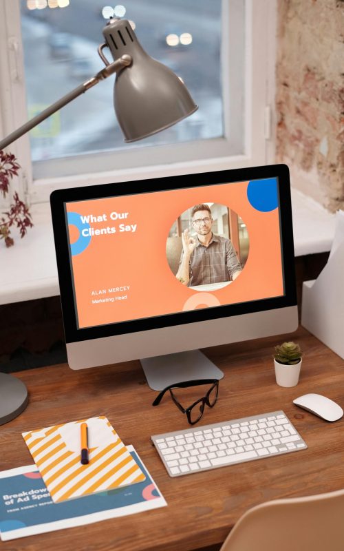 Stylish home office setup with computer showcasing client testimonials.